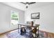 Bright home office with a ceiling fan, large windows, and a stylish rug at 5712 Wintergreen Dr, Raleigh, NC 27609