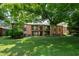 Exterior view of the building from the backyard showcasing balconies and grassy areas at 5804 Falls Of Neuse Rd # E, Raleigh, NC 27609