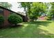 Scenic backyard view featuring lush green grass and mature trees, creating a serene outdoor space at 5804 Falls Of Neuse Rd # E, Raleigh, NC 27609