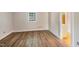 This bedroom features wood-look flooring and a bright window with plenty of natural light at 5804 Falls Of Neuse Rd # E, Raleigh, NC 27609