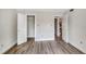 Light-filled bedroom with white trim, closet, and easy access to other rooms at 5804 Falls Of Neuse Rd # E, Raleigh, NC 27609