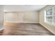The living room with new laminate floors and natural light is inviting at 5804 Falls Of Neuse Rd # E, Raleigh, NC 27609