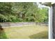 Fenced backyard features a level grassy area with a backdrop of mature trees at 59 Tuscarora Ln, Clayton, NC 27520