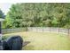 Large grassy backyard is enclosed by a wooden privacy fence for secluded outdoor activities at 59 Tuscarora Ln, Clayton, NC 27520