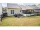 Large backyard with a patio, a screened-in porch, and a well-maintained lawn at 59 Tuscarora Ln, Clayton, NC 27520