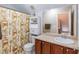 Bathroom with a single sink, toilet, and a shower with patterned curtain at 59 Tuscarora Ln, Clayton, NC 27520