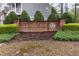 The Lionsgate community entrance features a brick sign and manicured landscaping at 59 Tuscarora Ln, Clayton, NC 27520