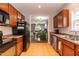 Functional kitchen with dark appliances, and view to dining and living spaces at 59 Tuscarora Ln, Clayton, NC 27520