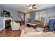 Bright living room with hardwood floors, fireplace, and open concept with dining area at 59 Tuscarora Ln, Clayton, NC 27520