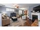 Comfortable living room with hardwood floors, neutral-toned furniture, fireplace, and an open layout at 59 Tuscarora Ln, Clayton, NC 27520