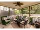 Screened porch with wicker furniture, ceiling fan, and view of backyard at 59 Tuscarora Ln, Clayton, NC 27520