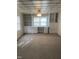 Spacious living room with carpet, custom shelving, and a decorative ceiling at 610 W Old Rd, Lillington, NC 27546