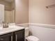This bathroom features a dark vanity with white basin sink and toilet at 65 N Wilders Ridge Way, Clayton, NC 27527
