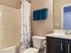 Bathroom with a shower-tub combo, dark vanity, and blue towels at 65 N Wilders Ridge Way, Clayton, NC 27527