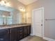 Bathroom with double sinks, granite countertop, tile floor, and glass enclosed shower at 65 N Wilders Ridge Way, Clayton, NC 27527