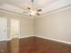 Spacious primary bedroom features hardwood floors, ceiling fan, and access to the en suite bathroom at 65 N Wilders Ridge Way, Clayton, NC 27527