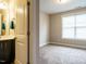Bedroom with connecting bath has neutral carpet and a large window at 65 N Wilders Ridge Way, Clayton, NC 27527