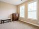 Bright bedroom with two windows, carpet, bench and dark wood dresser at 65 N Wilders Ridge Way, Clayton, NC 27527