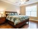 Comfortable bedroom featuring hardwood floors, ceiling fan, and natural light at 65 N Wilders Ridge Way, Clayton, NC 27527
