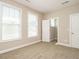 Bedroom with neutral walls and carpet, illuminated by two windows with blinds at 65 N Wilders Ridge Way, Clayton, NC 27527