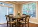 Cozy dining area with wood table, four chairs, and natural light at 65 N Wilders Ridge Way, Clayton, NC 27527