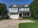 Charming two-story home with a two-car garage, covered porch, and well-maintained landscaping at 65 N Wilders Ridge Way, Clayton, NC 27527