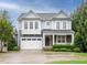 Charming two-story home with a two-car garage and a well-maintained front yard and stone accents at 65 N Wilders Ridge Way, Clayton, NC 27527