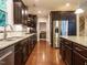 Gourmet kitchen featuring granite countertops, stainless steel appliances, and dark wood cabinetry at 65 N Wilders Ridge Way, Clayton, NC 27527