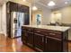 Spacious kitchen featuring a center island with granite countertops and stainless steel refrigerator at 65 N Wilders Ridge Way, Clayton, NC 27527