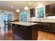 Elegant kitchen with dark wood cabinets, granite countertops, and stainless steel appliances at 65 N Wilders Ridge Way, Clayton, NC 27527