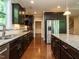 Spacious kitchen featuring granite countertops, dark wood cabinets, and stainless steel appliances at 65 N Wilders Ridge Way, Clayton, NC 27527
