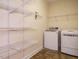 Laundry room with washer, dryer, and ample shelving for storage at 65 N Wilders Ridge Way, Clayton, NC 27527