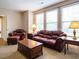 Cozy living room with elegant burgundy sofas, side tables, and a wooden coffee table at 65 N Wilders Ridge Way, Clayton, NC 27527