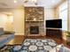 Inviting living room featuring stone fireplace, large windows, and hardwood floors at 65 N Wilders Ridge Way, Clayton, NC 27527