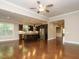 Open-concept living area with hardwood floors, with kitchen island and stainless steel appliances at 65 N Wilders Ridge Way, Clayton, NC 27527