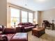 Inviting living room featuring plush leather seating and large windows for ample natural light at 65 N Wilders Ridge Way, Clayton, NC 27527
