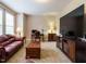 Comfortable living area showcasing a large screen TV, warm lighting, and plush carpet at 65 N Wilders Ridge Way, Clayton, NC 27527