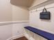 Functional mudroom area with bench seating, storage, and coat hooks at 65 N Wilders Ridge Way, Clayton, NC 27527