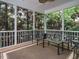 Relaxing screened porch with outdoor seating and views of the surrounding trees at 65 N Wilders Ridge Way, Clayton, NC 27527
