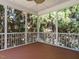 Cozy screened porch with wood flooring, offering a private outdoor space surrounded by lush greenery at 65 N Wilders Ridge Way, Clayton, NC 27527