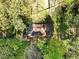 Aerial view of the home's roof, showcasing its secluded lot surrounded by mature trees at 6709 Johnsdale Rd, Raleigh, NC 27615