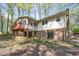 Back exterior of home showcasing brick foundation and a sunroom addition at 6709 Johnsdale Rd, Raleigh, NC 27615