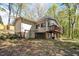 Exterior of home with a deck, open yard, and lots of trees at 6709 Johnsdale Rd, Raleigh, NC 27615