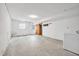 Unfinished basement area with concrete floor, washer, dryer, and access to the backyard at 6709 Johnsdale Rd, Raleigh, NC 27615