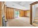 Spacious basement with wood paneling, fireplace, and sliding glass doors to the outside at 6709 Johnsdale Rd, Raleigh, NC 27615