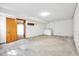 Unfinished basement area with concrete floor, washer, dryer, and access to additional storage at 6709 Johnsdale Rd, Raleigh, NC 27615