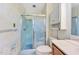Bathroom showcasing a shower with glass door, a toilet, and a vanity with storage at 6709 Johnsdale Rd, Raleigh, NC 27615