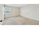 A bright bedroom featuring a window with blinds and neutral colored walls at 6709 Johnsdale Rd, Raleigh, NC 27615