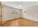 Bright bedroom with hardwood floors and a window at 6709 Johnsdale Rd, Raleigh, NC 27615