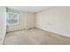 A bright bedroom featuring a window with blinds and neutral colored walls at 6709 Johnsdale Rd, Raleigh, NC 27615